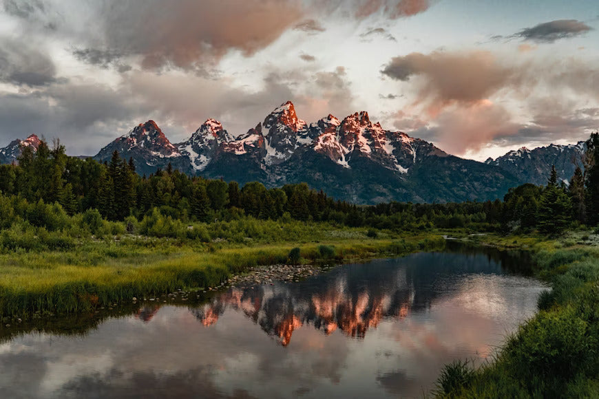 Mountain landscape with reflective river representing kratom in Wyoming and statewide legality updated