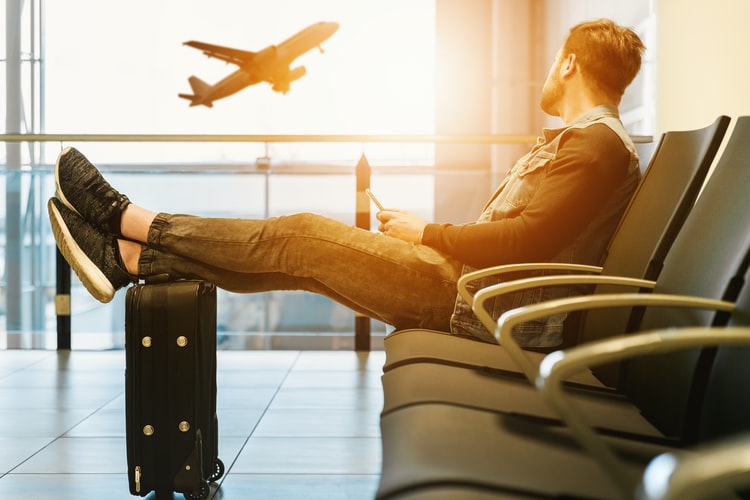 man sitting at an airport|Kratom Travel