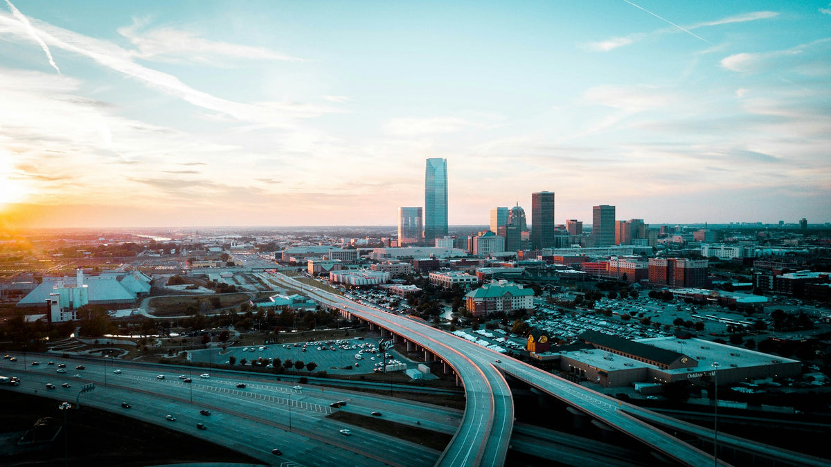 Oklahoma City skyline at sunset with downtown highways, which is located near where to buy kratom in Oklahoma